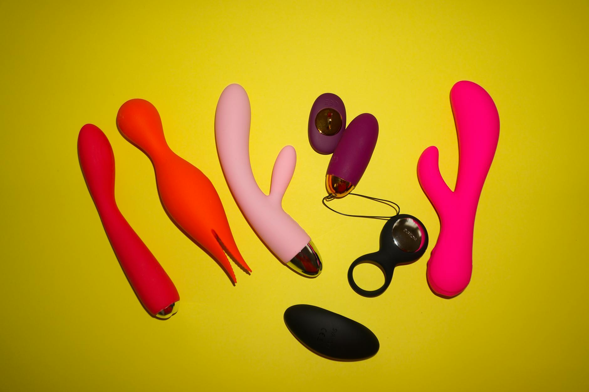 A blue silicone vibrator held in hand against a purple background, symbolizing gentle pleasure and self-care