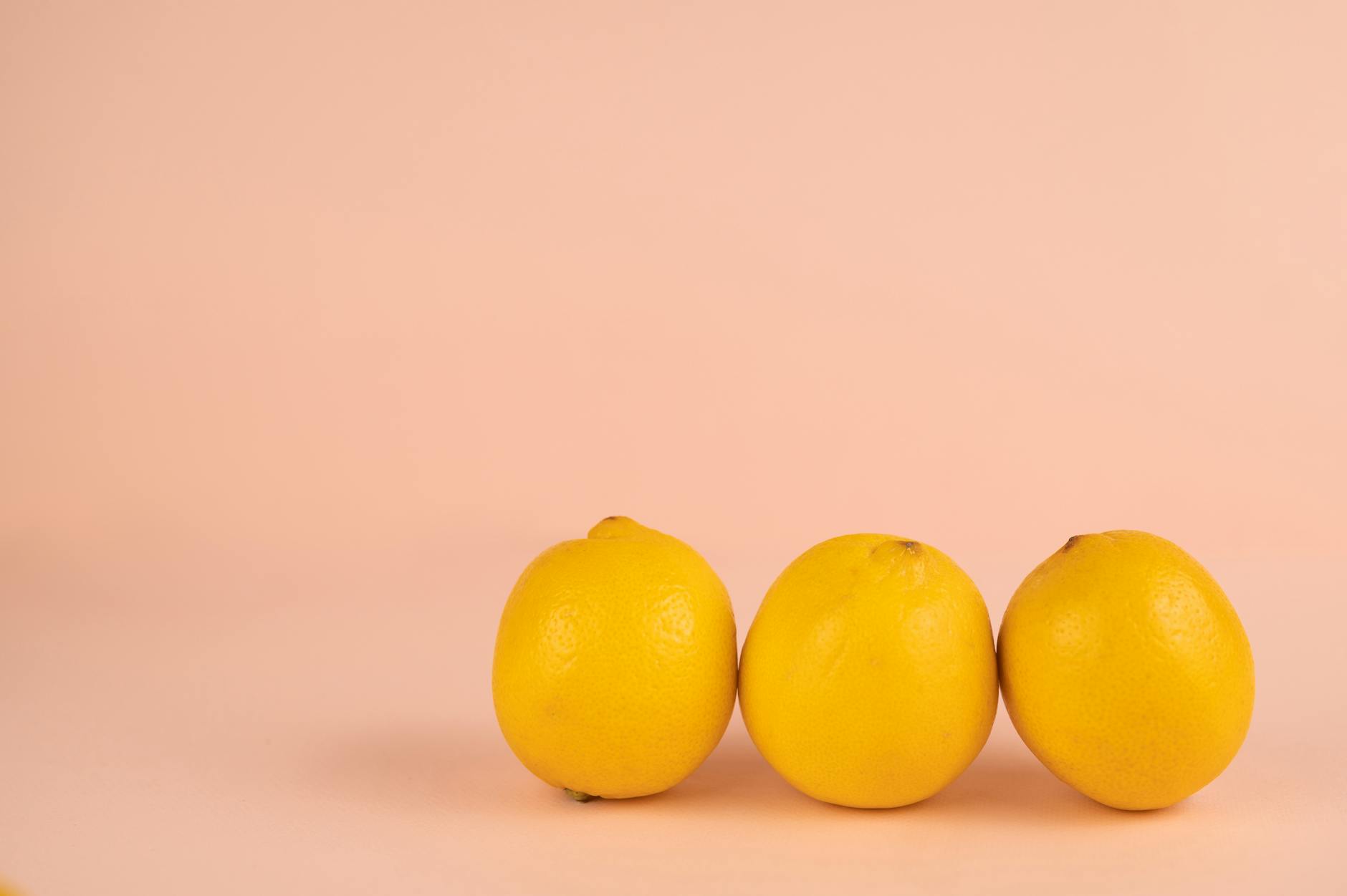 Bright yellow lemons on a pastel background, symbolizing a fresh restart